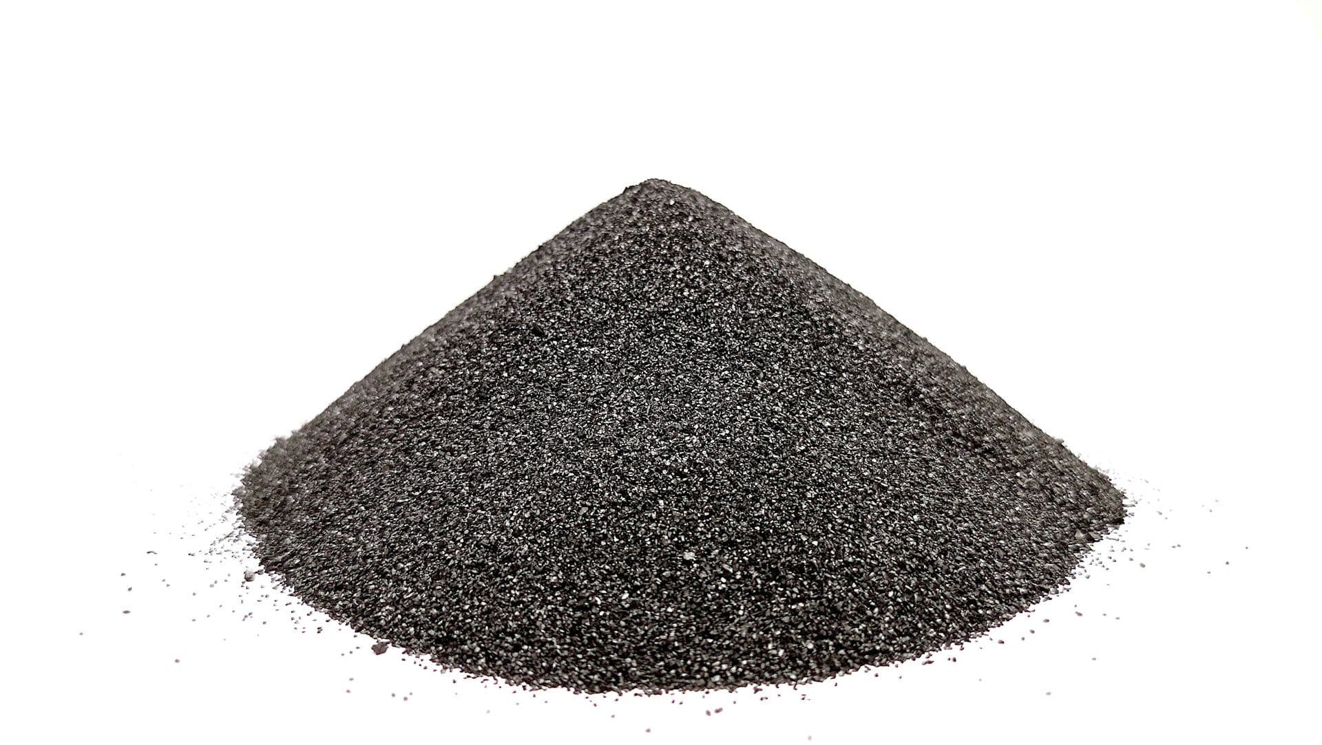 A conical heap of fine black powdered activated carbon